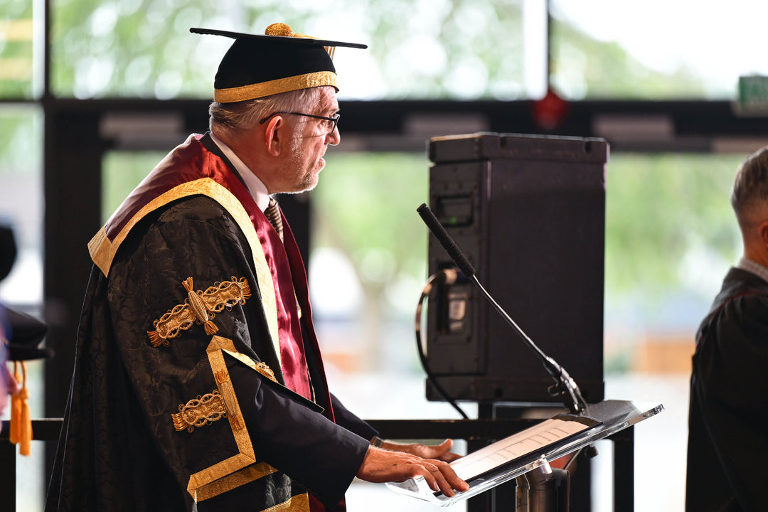 Ceremonial gown and Stiff skull mortarboard