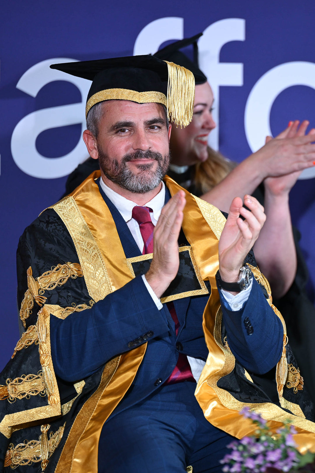 Chancellors gown and stiff skull mortarboard